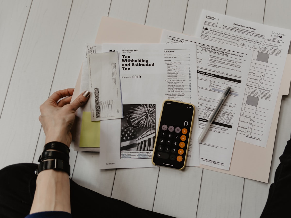 Tax preparation paperwork and a calculator on a desk